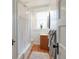 Bathroom featuring a shower, vanity, and window which adds natural light at 1817 - 1821 Vine Vine St, Denver, CO 80206