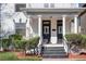 Charming front entry with double doors, white columns, and manicured landscaping at 1817 - 1821 Vine Vine St, Denver, CO 80206