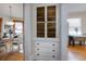 Hallway with wood floors, built-in white storage cabinet, and dining room view at 1817 - 1821 Vine Vine St, Denver, CO 80206