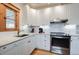 Bright kitchen showcasing white cabinets, granite counters, stainless steel appliances, and wood floors at 1817 - 1821 Vine Vine St, Denver, CO 80206