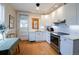 Cozy kitchen featuring white cabinetry, granite countertops, stainless steel appliances, and wood flooring at 1817 - 1821 Vine Vine St, Denver, CO 80206