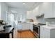 Bright and modern kitchen with white cabinets and stainless steel appliances at 1817 - 1821 Vine Vine St, Denver, CO 80206