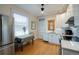 Kitchen with white cabinets, granite countertops, stainless appliances, and breakfast table at 1817 - 1821 Vine Vine St, Denver, CO 80206