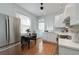 Bright kitchen featuring stainless steel appliances, white cabinets, and a cozy dining area with natural light at 1817 - 1821 Vine Vine St, Denver, CO 80206