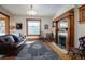 Cozy living room with a classic fireplace, rich wooden accents, and a comfortable leather couch at 1817 - 1821 Vine Vine St, Denver, CO 80206
