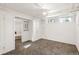 Spacious basement area with neutral carpet, natural light, and white-painted walls and trim at 1422 Ivy St, Denver, CO 80220