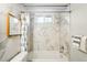 Bathroom featuring marble tile backsplash, shower-tub combo, and shower curtain at 1422 Ivy St, Denver, CO 80220