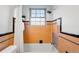 Updated bathroom with a shower/tub, white shower curtain, and colorful orange and black tile details at 1422 Ivy St, Denver, CO 80220
