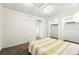 Cozy bedroom with neutral carpet, closet space, and simple decor, featuring a comfortable bed at 1422 Ivy St, Denver, CO 80220