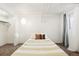 Brightly-lit bedroom with gray curtains, neutral carpet, and closet with rack at 1422 Ivy St, Denver, CO 80220