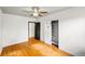 Comfortable bedroom featuring hardwood floors, a ceiling fan, and closet with built-in shelving at 1422 Ivy St, Denver, CO 80220
