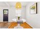 Charming dining area featuring a decorative light fixture, textured walls, and warm-toned wood flooring at 1422 Ivy St, Denver, CO 80220
