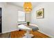 Charming breakfast nook featuring a round table, woven pendant lighting, and a sunny window at 1422 Ivy St, Denver, CO 80220