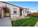 Home exterior with charming brickwork, quaint entrance, and well-maintained lawn at 1422 Ivy St, Denver, CO 80220
