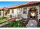 Charming home featuring a red tile roof, arched entrance, and well-maintained front yard with flower beds at 1422 Ivy St, Denver, CO 80220