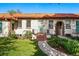 Charming home featuring a red tile roof, arched entrance, and well-maintained front lawn at 1422 Ivy St, Denver, CO 80220