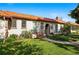 Charming home featuring a red tile roof, arched entrance, with a well-maintained lawn and landscaping at 1422 Ivy St, Denver, CO 80220