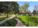 View from the front porch showcasing the sidewalk, large shade trees, and a spacious grassy yard at 1422 Ivy St, Denver, CO 80220