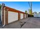 Angled view of garages with white doors, providing a practical parking solution for residents at 1422 Ivy St, Denver, CO 80220