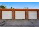 Close-up of brick garages with numbered doors, ideal for organized parking and property management at 1422 Ivy St, Denver, CO 80220