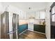 Well-lit kitchen featuring a stainless steel refrigerator, butcher block countertops, and classic subway tile at 1422 Ivy St, Denver, CO 80220