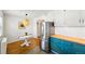 Cozy kitchen with stainless steel refrigerator, two-tone cabinetry, and a view into the adjacent dining area at 1422 Ivy St, Denver, CO 80220