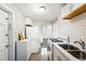 Efficient kitchenette featuring stainless steel sink and gas range with subway tile backsplash at 1422 Ivy St, Denver, CO 80220