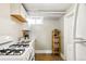 Bright kitchenette with a gas range, white subway tile backsplash, and a stainless steel sink basin at 1422 Ivy St, Denver, CO 80220