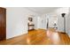 Spacious living room featuring hardwood floors, white walls, and an open layout with arched doorways at 1422 Ivy St, Denver, CO 80220