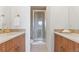 Bathroom with double vanity, tiled shower, and modern fixtures at 8711 E Hampden Ave # 21, Denver, CO 80231
