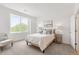 Bright bedroom with a large window, neutral paint, and cozy furnishings at 8711 E Hampden Ave # 21, Denver, CO 80231