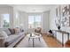 Bright, modern living room boasts hardwood floors and large windows offering ample natural light at 8711 E Hampden Ave # 21, Denver, CO 80231