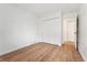 Bedroom with hardwood floors and closet with white bi-fold doors at 3600 S Pierce St # 1-104, Lakewood, CO 80235