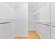 Walk-in closet with white shelving and hardwood floors at 3600 S Pierce St # 1-104, Lakewood, CO 80235