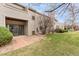 Townhome exterior featuring a patio, sliding glass door, small yard, and brick walkway at 3600 S Pierce St # 1-104, Lakewood, CO 80235
