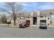 Exterior view of the condo complex featuring ample parking and a well-maintained facade at 3600 S Pierce St # 1-104, Lakewood, CO 80235