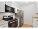 Updated kitchen features stainless steel appliances, granite countertops, and modern finishes at 3600 S Pierce St # 1-104, Lakewood, CO 80235