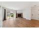 Open-concept living room with stone fireplace and sliding glass doors for natural light at 3600 S Pierce St # 1-104, Lakewood, CO 80235