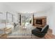 Bright living room features a stone fireplace, sliding glass doors, and modern decor at 3600 S Pierce St # 1-104, Lakewood, CO 80235