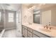 Elegant bathroom with dual sinks, white cabinets, and a glass-enclosed shower at 4353 S Liverpool Ct, Aurora, CO 80015