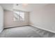 Bright bedroom with neutral walls, plush carpet, and a window with a view at 4353 S Liverpool Ct, Aurora, CO 80015