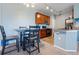 Eat-in kitchen boasts wood cabinetry and updated appliances, with dining area table and chairs at 2682 S Cathay Way # 307, Aurora, CO 80013