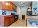 Galley kitchen with wood cabinets, tile backsplash, and stainless steel appliances at 2682 S Cathay Way # 307, Aurora, CO 80013