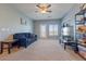 Inviting living room with a blue sofa, ceiling fan, and sliding door for natural light at 2682 S Cathay Way # 307, Aurora, CO 80013