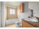 Compact bathroom featuring tile walls, vanity, toilet, and bathtub with shower at 16325 E Alabama Dr, Aurora, CO 80017