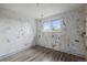 Bedroom features hardwood floors, with a double hung window and painted blue trim at 16325 E Alabama Dr, Aurora, CO 80017