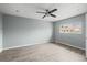 Comfortable bedroom with a ceiling fan and a view of the outdoors from the bright window at 16325 E Alabama Dr, Aurora, CO 80017