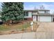 Charming two-story home featuring a well-maintained front yard, brick accents, and an attached two-car garage at 16325 E Alabama Dr, Aurora, CO 80017