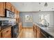 Spacious kitchen showcasing wood cabinets and modern appliances, ready for culinary adventures at 16325 E Alabama Dr, Aurora, CO 80017