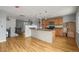 Spacious kitchen with hardwood floors, center island, and stainless steel microwave at 16325 E Alabama Dr, Aurora, CO 80017